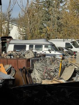 Scrap Metal Yard with Vans and Recyclable Materials