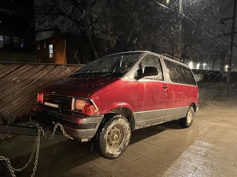 Old Van in Rain at Scrap Metal Recycling Yard