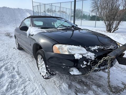 Snow-Covered Car Ready for Scrap Metal Recycling